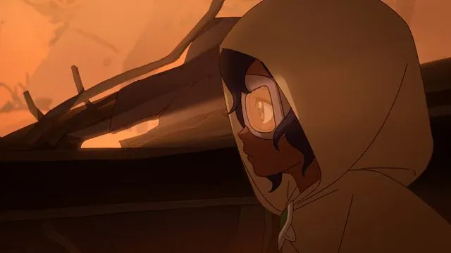 Episode 101 press still: Pavi in a hood and goggles in a dark, ember-lit ruin