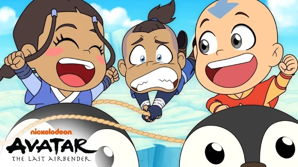 First-look still from the chibi-style 2D shorts shown at NYCC 2025: chibi Katara, Sokka and Aang riding penguins, with the Nickelodeon Avatar logo