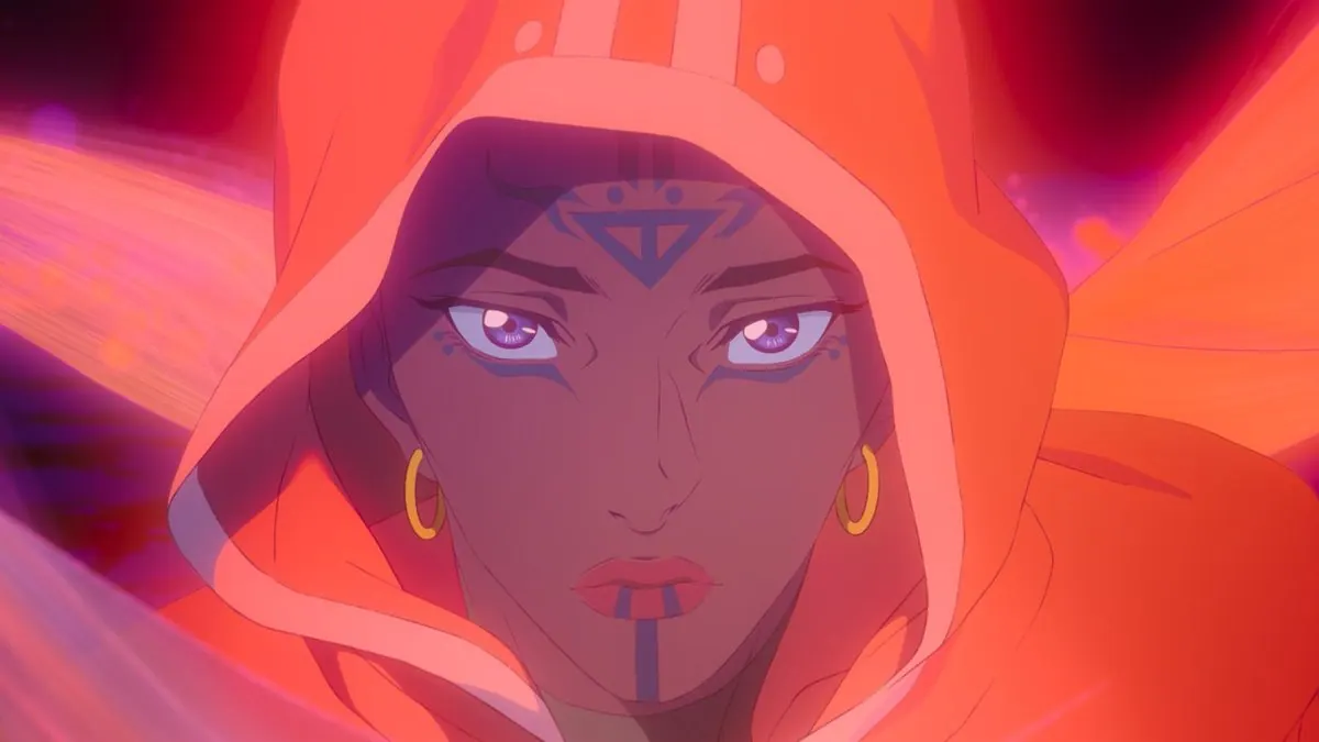 First-look close-up of Avatar Sonam (Freida Pinto) in an orange hood, with facial markings and violet eyes