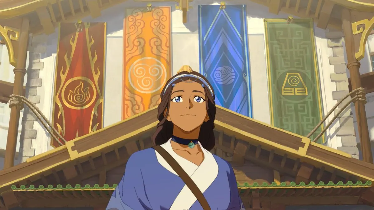 First-look still of adult Katara (Jessica Matten) standing beneath banners of the four elements