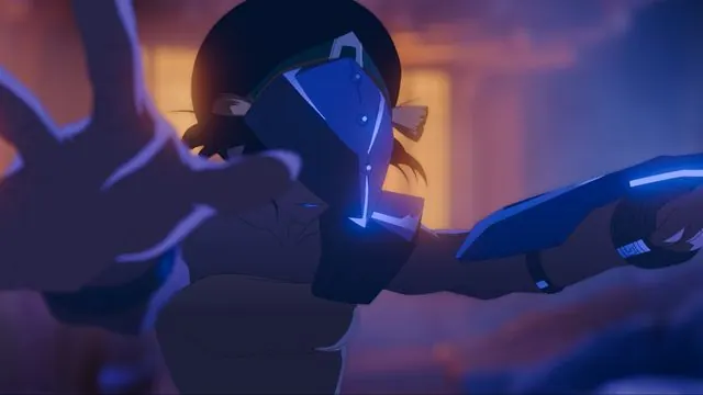 First-look still of adult Toph (Dionne Quan) in a metal face mask and armor, reaching toward the camera in blue night light