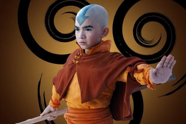 Season 1 character portrait: Gordon Cormier as Aang in front of the Air Nomad emblem