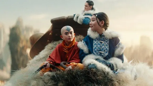 Season 1 still: Aang, Katara and Sokka riding Appa through the sky