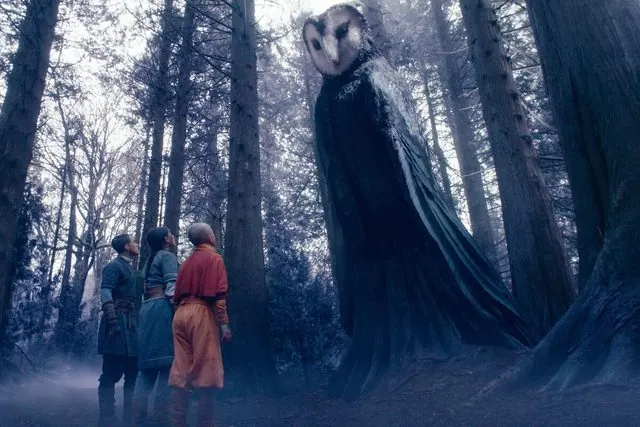 Season 1 still: Sokka, Katara and Aang facing the giant owl spirit Wan Shi Tong in a misty forest