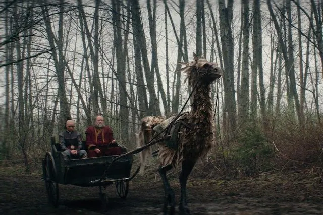 Season 1 still: Zuko and Iroh riding in a cart pulled by a large creature through a bare forest
