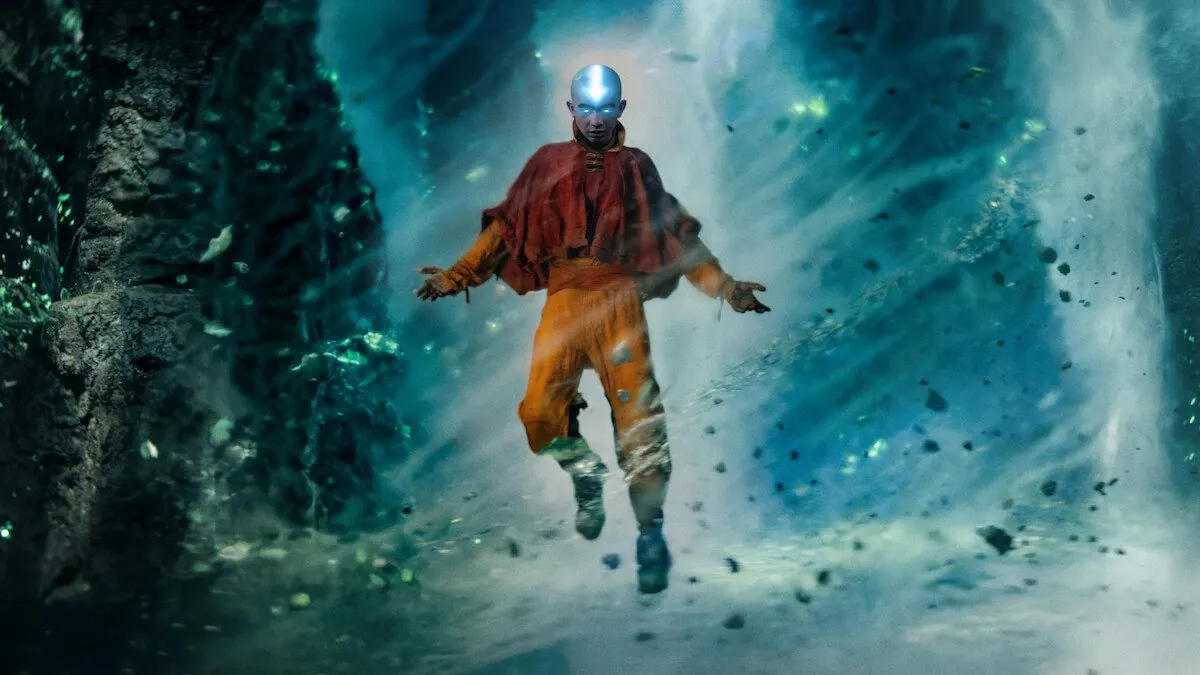 Season 2 still: Aang hovering in the Avatar State with glowing tattoos in a swirling crystal cavern