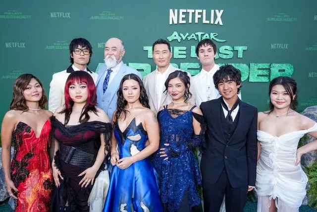 Season 2 premiere event: the cast posing in front of the Netflix Avatar: The Last Airbender backdrop