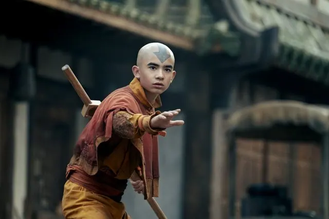 Season 2 first-look still: an older Gordon Cormier as Aang in an airbending stance with his staff
