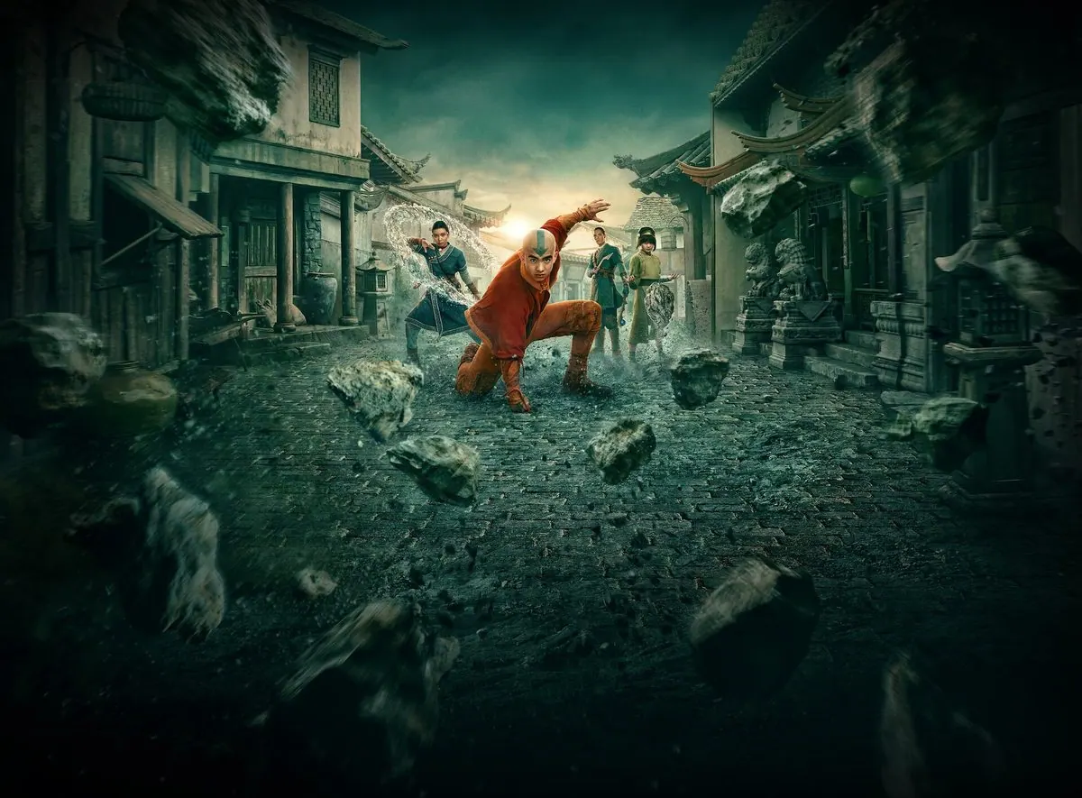 Season 2 key art without text: Aang crouching mid-airbend on a cobblestone Earth Kingdom street with Katara waterbending, Sokka and Toph behind, boulders flying