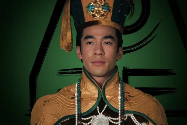 Season 2 character portrait: Justin Chien as Earth King Kuei in golden imperial robes and headdress
