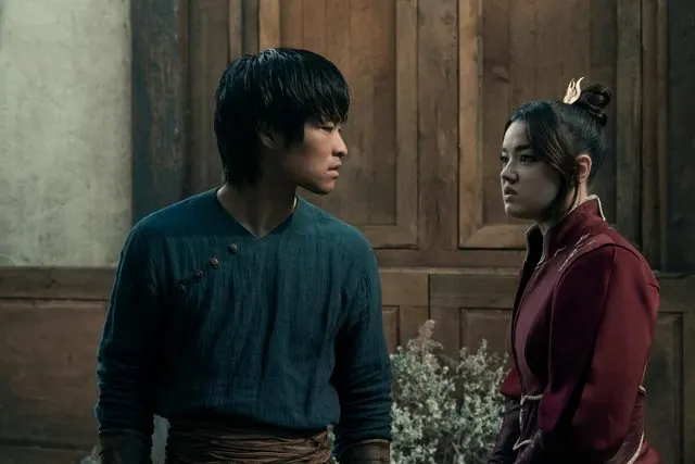 Season 2 still: Dallas Liu as Zuko and Elizabeth Yu as Azula facing each other indoors