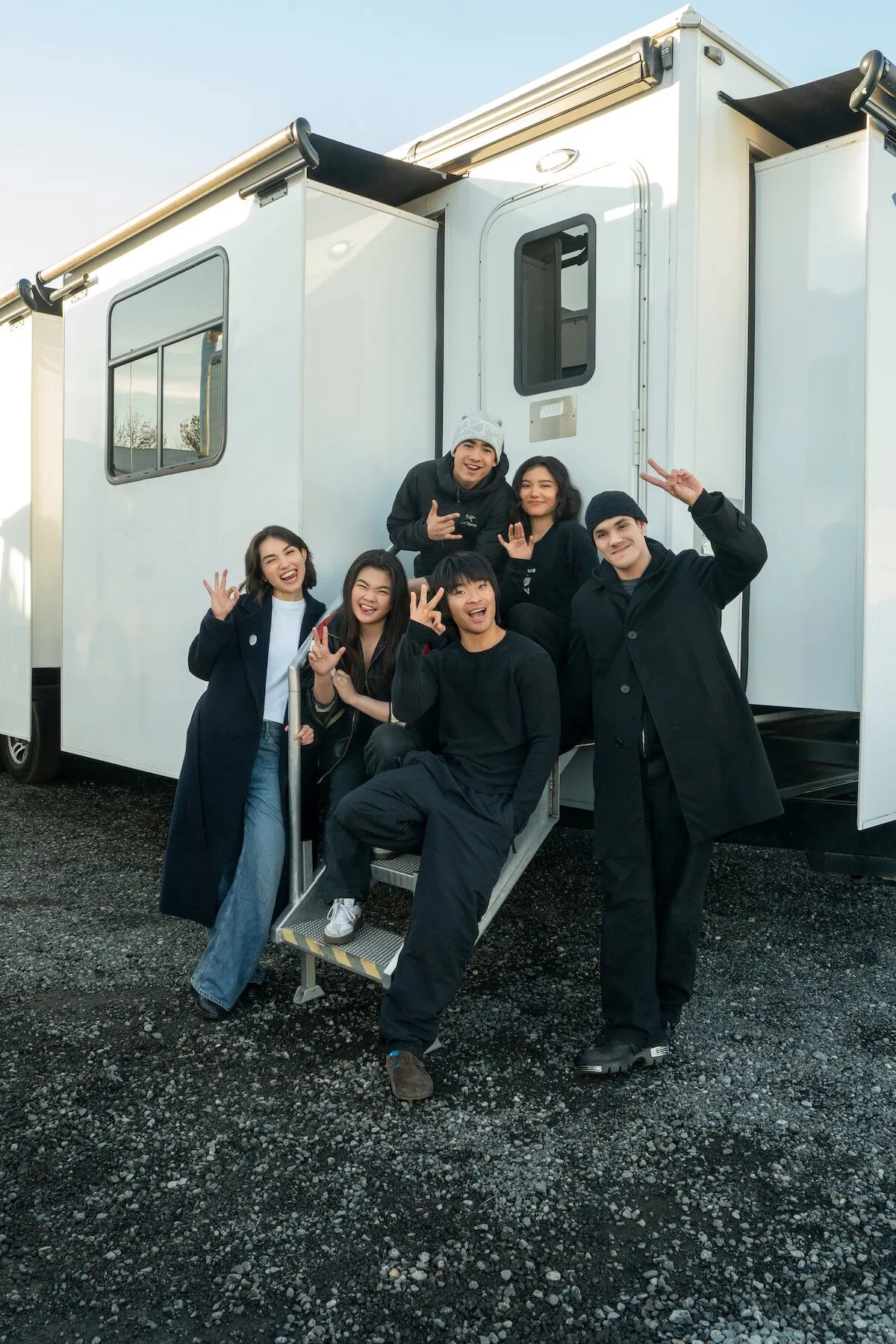 Season 3 production wrap photo: Maria Zhang, Miya Cech, Dallas Liu, Gordon Cormier, Kiawentiio and Ian Ousley posing by a trailer on set