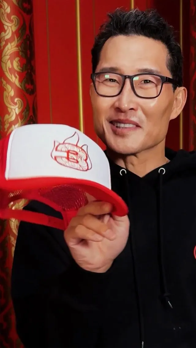 Daniel Dae Kim holding a cap with a '3' and the Fire Nation emblem (Season 3 announcement photo)