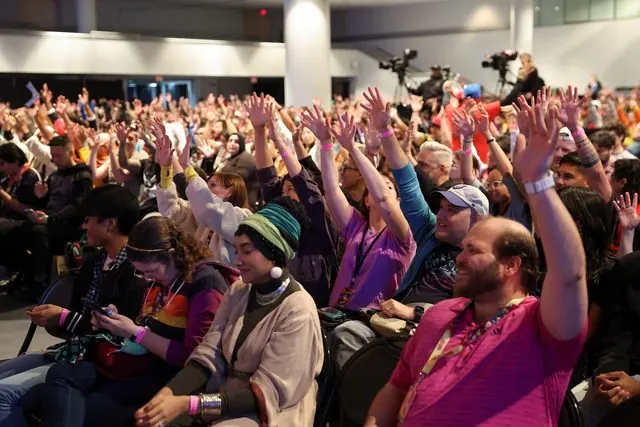 Cheering fans with arms raised in the audience of the NYCC 2026 Avatar: Seven Havens Main Stage panel