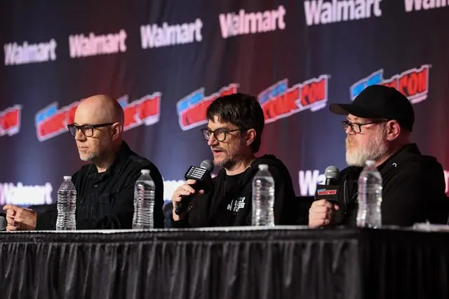 Michael Dante DiMartino (left) and Bryan Konietzko (center, speaking) at the panel table at NYCC 2026, with a fellow Seven Havens producer at right