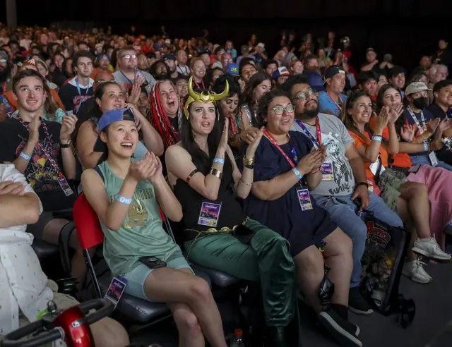 Excited fans, some in Avatar cosplay, cheering in Hall H during the SDCC 2026 Avatar panel