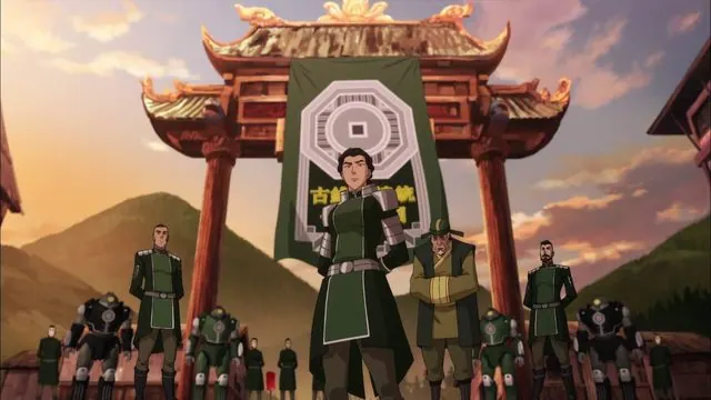 Book Four still: Kuvira in armor with Earth Empire soldiers and mecha suits under a town gate hung with her banner